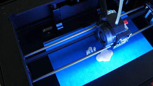 3D printer illuminated with blue light