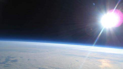 The edge of space with the sun and the top of the atmosphere in view
