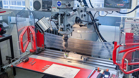 XYZ Milling Machine with tools on the bed