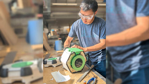 Student in workshop building assembling plastic casing on the bench