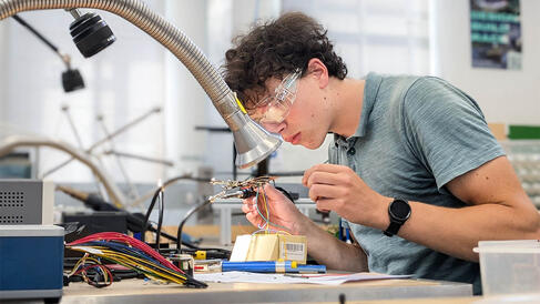 Electronics Student inspecting their soldering