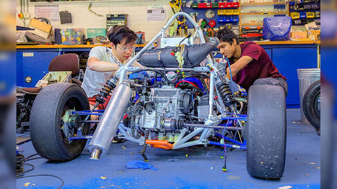 Students working on a formula student racecar