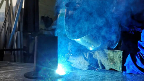 Welding with smoke and blue light