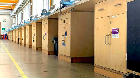 a long row of wooden cupboards under a workbench