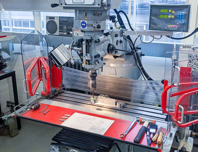 XYZ Milling Machine with tools on the bed