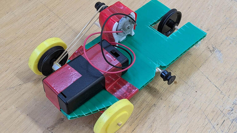 mini electric car made from kebab sticks and elastic bands